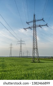 High voltage masts of a power line in spring