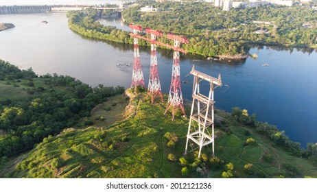 high voltage pillar, overhead power line, industrial background. power lines on the river - Powered by Shutterstock