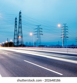 high voltage post.High-voltage tower sky background,besides the highway - Shutterstock ID 202648186
