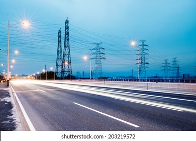 high voltage post.High-voltage tower sky background,besides the highway - Shutterstock ID 203219572