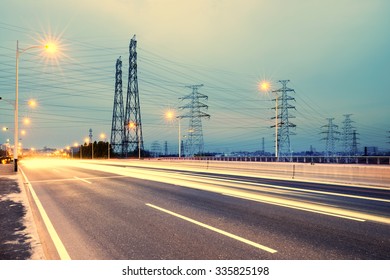 high voltage post.High-voltage tower sky background,besides the highway - Shutterstock ID 335825198