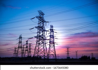 High voltage power cord. Sub-station. High voltage transmission tower. A distribution substation with power lines and transformers.
