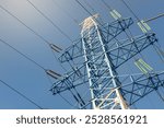 high voltage power line, network of high voltage electricity cables with a blue sky as a background