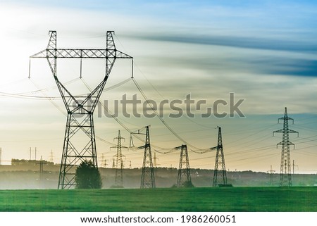 High voltage power line on industrial electricity line tower for electrification rural countryside