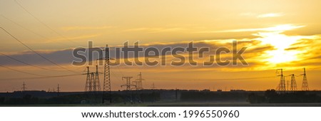 High voltage power line on industrial electricity line tower for electrification rural countryside. Energy transmisson with overhead power line. Wide photo