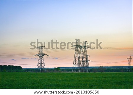 High voltage power line on industrial electricity line tower for electrification rural countryside.