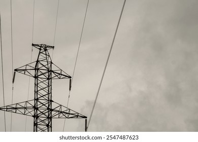 High voltage power lines and pylons with cloudy sky background. - Powered by Shutterstock