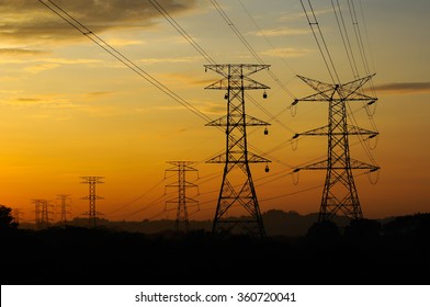 High voltage power tower and power lines sunset