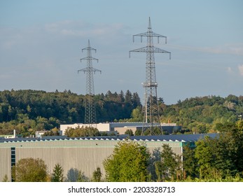 High Voltage Pylons Of An Overhead Line In The Field