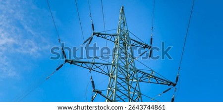 High voltage tower with power lines. Metal wires on high-voltage tower for electricity transmission over long distances