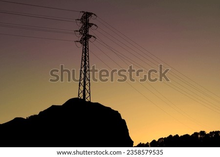 High voltage towers in the mountain at sunset in Spain