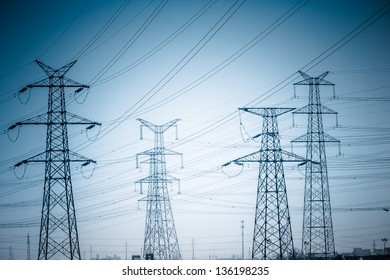 High voltage towers with sky background. blue toned images. - Shutterstock ID 136198235