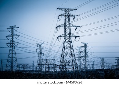 High voltage towers with sky background.
