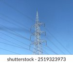 High Voltage Transmission Electricity Tower, Huge Electricity Tower With Long Wires In Blue Sky Long Power Communication Tower, Tower With Blue Sky And Sunny Weather