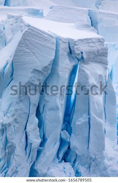 High walls of ice form caves and cracks in\
glaciers with a shimmering blue\
passage