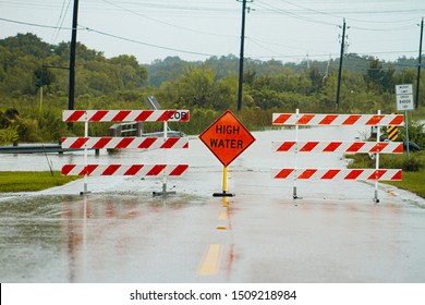 high water sign blocking flooded road after tropical storm Imelda