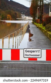 High water warning street sign in germany. Spa town embankment under water. Selected focus. - Shutterstock ID 2249697319