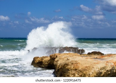 High Wave Splashing On The Cliff. Wild, Restless, Rough Mediterranean Sea, With Coast Rocks. Big Waves Crashes Against The Rocks. Crete Island. Greece