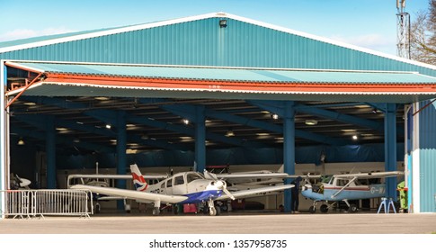 HIGH WYCOMBE, ENGLAND - MARCH 2019: Piper Warrior Light Aircraft In British Airways Colour Scheme Parked In A Hanger At Wycombe Air Park.