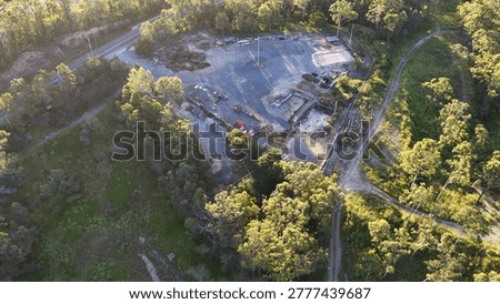 High-angle drone shot of a construction yard and storage bins in Gold Coast, Australia.