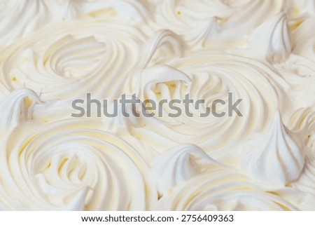 A high-angle, full-frame background showing the delicate, cracked surface of a freshly baked white meringue crust.