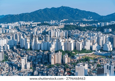 High-angle panoramic view of dense residential apartment complexes and urban cityscape in southern Seoul on a clear summer day