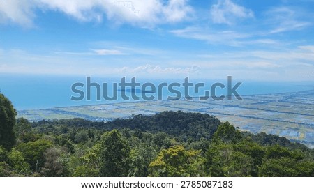 High-angle panoramic view of lush green forests, vast agricultural flatlands, and an island in the calm blue sea under a bright sky.