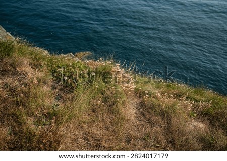 High-angle perspective emphasizing the height of the coastal cliffs above the Irish Sea.