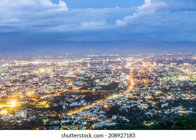 High-angle photos of Chiang Mai from Doi Suthep is a city surrounded by trees.