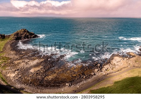 High-angle scenic view of the dramatic basalt rock formations and bay at Giant's Causeway, Northern Ireland