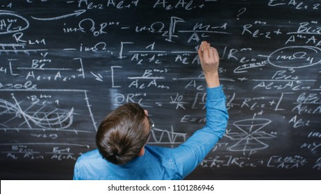 High-Angle Shot of a Brilliant Young Student Writing Complex Mathematical Formula/ Equation on the Blackboard.