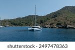 High-angle shot of a catamaran making its way through calm waters.