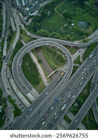 High-angle shot of a complex highway interchange with heavy traffic. Perfect for transportation, infrastructure, and urban development projects.