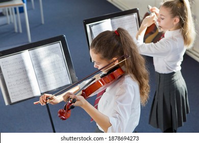 High-angle Shot Of A High School Students Playing Violin And A Flute In A Music Class.