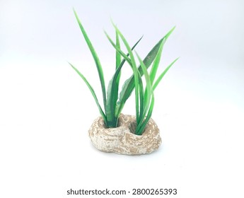 High-angle shot looking down at a small artificial aquatic grass ornament with a double-socket ceramic rock base, isolated on a clean white background. High-quality product photo tailored for e-commerce, pet supply catalogs, and aquascaping accessories.
