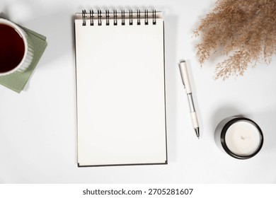 High-angle vertical shot of a blank open notebook with aesthetic boho decor. Ideal for Instagram stories, Pinterest pins, or social media content backgrounds.