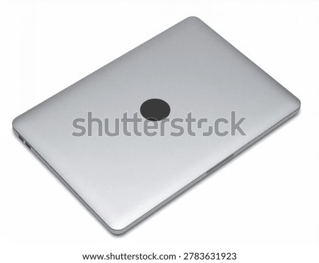 A high-angle view of a closed silver laptop computer with a blank lid, isolated on a clean white background.