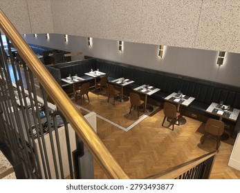 High-angle view of an empty upscale restaurant dining area with elegant lighting and furniture