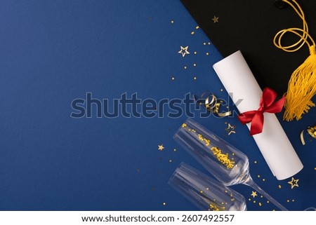 High-angle view of a graduation setup featuring a diploma, cap, and celebratory items. The theme showcases achievements and joy during this milestone occasion