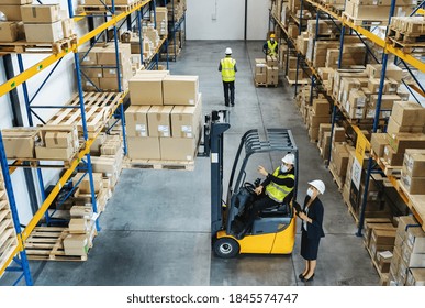 High-angle view of group of workers with manager working indoors in warehouse, coronavirus concept.