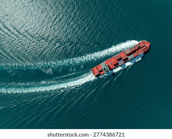 A highangle view of a large container vessel traversing the open sea illustrating global trade logistics and international shipping supply chain operations.