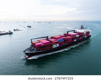 A highangle view of a massive cargo vessel loaded with colorful shipping containers traveling through open sea lanes for international trade and global logistics operations.