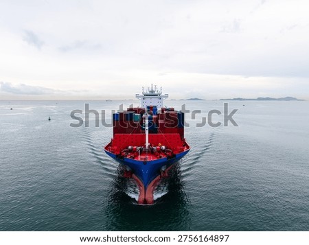 A highangle view of a massive cargo vessel crossing the sea under a cloudy sky representing global trade logistics and industrial supply chain networks.