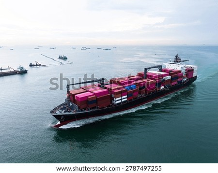 A highangle view of a massive cargo vessel loaded with colorful shipping containers traveling through open sea lanes for international trade and global logistics operations.