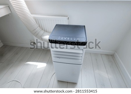 High-angle view of smart mobile monoblock air conditioner unit with electronic control panel and led icons
