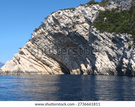 High-angle view of tilted limestone sedimentary strata on the coastal cliffs of Bisevo Island, Croatia. Excellent example of geological stratification and tectonic activity.