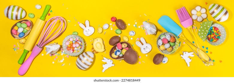 High-colored Easter baking background, Easter sale, party invitation flaylay, Colorful Easter eggs, chocolate eggs and bunny rabbit with sugar sprinkles on bright yellow background top view copy space