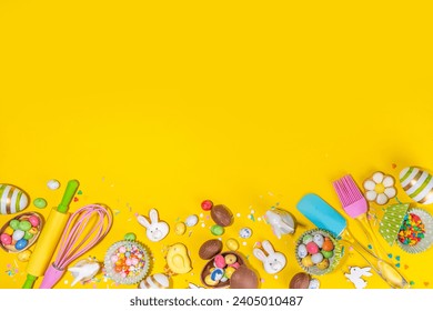 High-colored Easter baking background, Easter sale, party invitation flaylay, Colorful Easter eggs, chocolate eggs and bunny rabbit with sugar sprinkles on bright yellow background top view copy space
