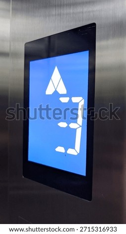 Highcontrast touchscreen panel showing elevator floor with logo