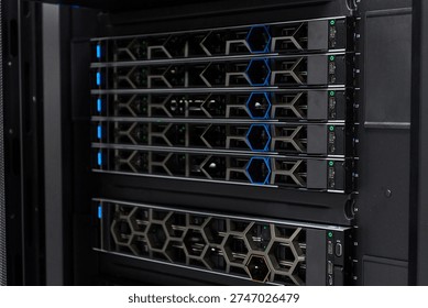 High-density server rack in a data center with modern network equipment and blue status lights